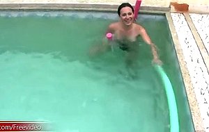Playful tanned t-girl strips down and jerks off in the water