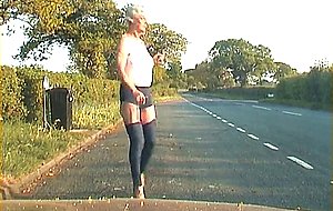 Mature shemale walking on a road