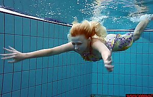 Blonde in a dress in a pool