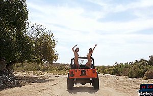 Busty Asian and brunette babe go to the sun in a Jeep