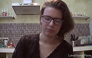 Solo girl with glasses chatting in the kitchen