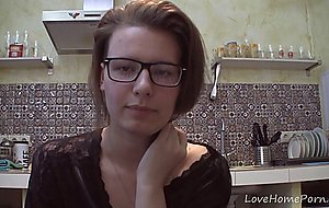 Solo girl with glasses chatting in the kitchen