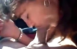 Brunette slut sucks cock in a car