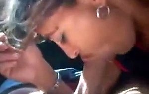 Brunette slut sucks cock in a car