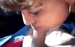 Brunette slut sucks cock in a car