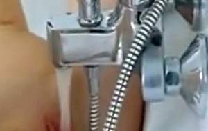 Skinny coed opening vagina in the bath