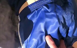 Male doll wears nylon Adidas shorts