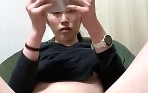 Japanese woman masturbates while watching adult video