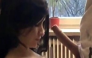 Buxom chick sucks and strokes a stiff dick